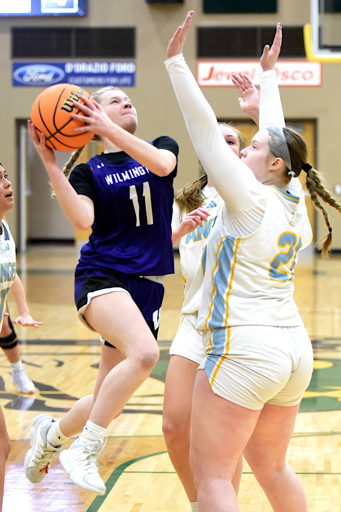 Wilmington's Nina Egizio (11) shoots a layup contested by Joliet Catholic Academy's Emma Birsa during an IHSA Class 2A Coal City Regional semifinal Tuesday, Feb. 18, 2025.
