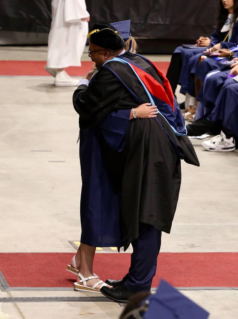A new Oswego East High School graduate hugs Dr. Andalib Khelghati, Superintendent of Schools for District 308 at the Class of 2024 Commencement Ceremony on Saturday, May 18, 2024 in DeKalb.