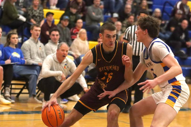 Richmond-Burton’s Jace Nelson, left, works under the hoop against Johnsburg’s Josh Kaunus in varsity boys basketball onTuesday, Dec. 9, 2025, at Johnsburg High School in Johnsburg.