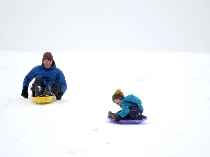 Gary Nelson of Wheaton and his son, Hawthorne, 5, sled down the hill at Northside Park in Wheaton on Wednesday, Jan. 25, 2023.