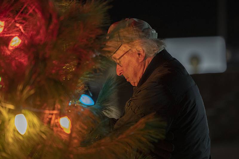 Terry Stephenitch of the Dixon VFW changes a bulb from red to green Saturday, Dec. 6, 2025, to signify the return of the remains of an Illinois soldier who had been missing in action.