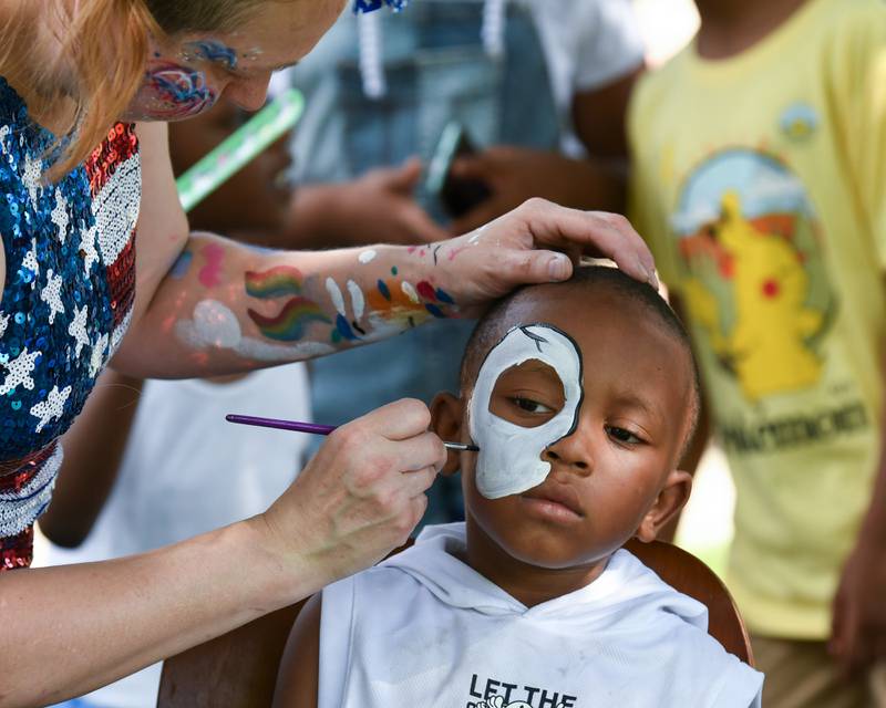 Milo Tittle, 4, of DeKalb gets his face painted with a skull on Tuesday July 4, 2023 during the city's annual Fourth of July celebration.