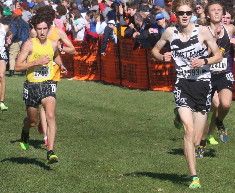 Sycamore's Corey Goff and Kaneland's Collin Reutimann compete in the Class 2A State Cross Country race on Saturday, Nov. 4, 2023 at Detweiller Park in Peoria.