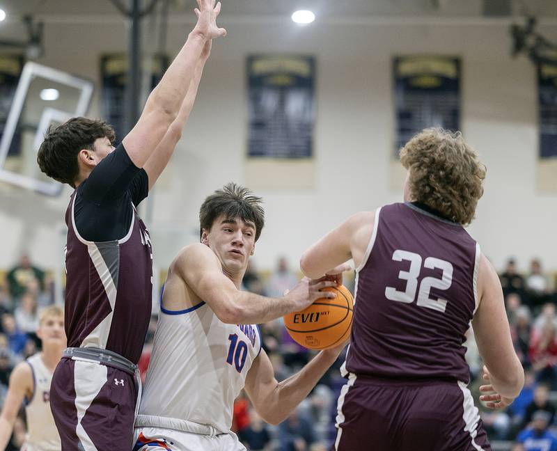 Eastland’s Zyacn Haverland works against against Dakota’s Carson Mayer (left) and Braxton Niedermeier Wednesday, March 5, 2025, during the Class 1A boys basketball Sectional semifinal at Pecatonica High School.