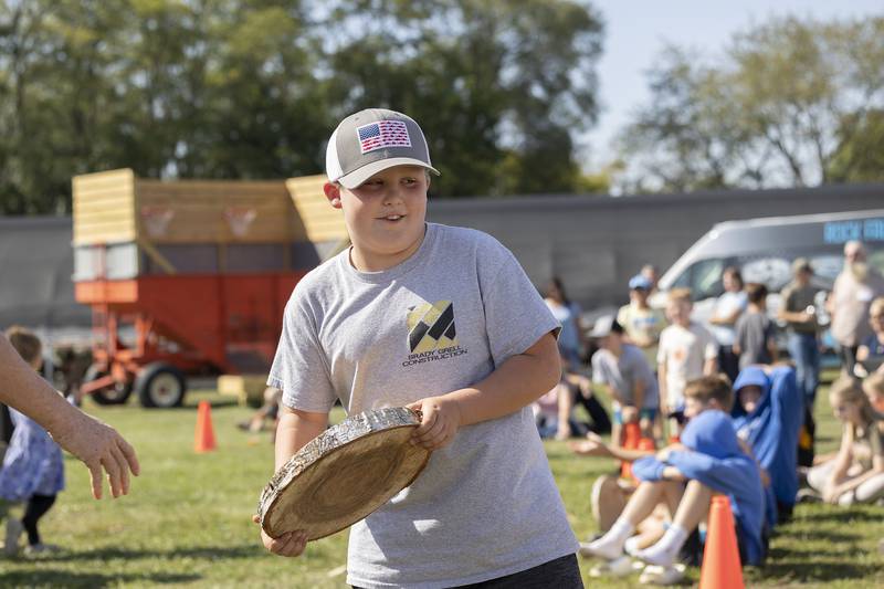 Macklin Grell, 9, of Rock Falls takes his second place prize Saturday, October 5, 2024, during a chainsaw impression competition.
