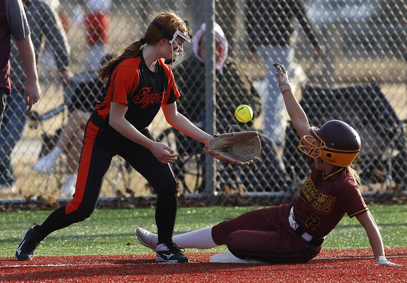 Crystal Lake Central's Makayla Malone tries to come up with the ball as Richmond-Burton's Adrianna Portera slides into third base during during a nonconference softball game Wednesday March 16, 2022, between Crystal Lake Central and Richmond-Burton at Lippold Park in Crystal Lake.