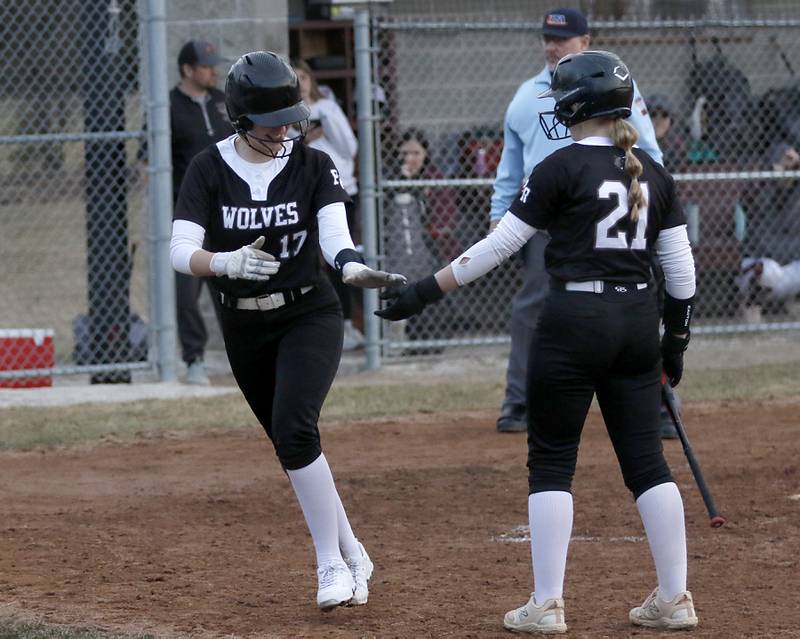 Prairie Ridge's Parker Frey receives a high five from teammate, M-K Center, after Frey score the game tying run during a nonconference softball game  on Tuesday, March 18, 2025, at Richmond-Burton High School. The game was called because of darkness after the 7th inning.