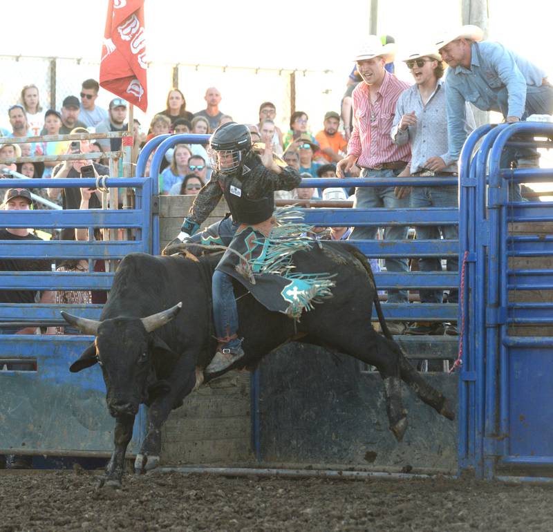 Megan Clarida rides a bull during the T and A rodeo at the Lee County Fair on Saturday, July 29, 2023.