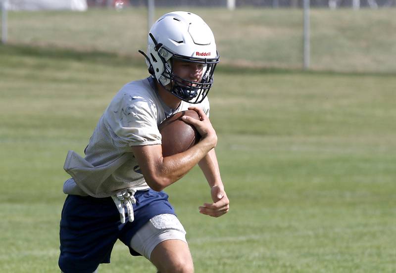 Cary-Grove's Jason Ritter runs with the ball while returning a kick-off during Cary-Grove’s first football practice of the upcoming season on Monday, August 11, 2025, at Cary-Grove High School.