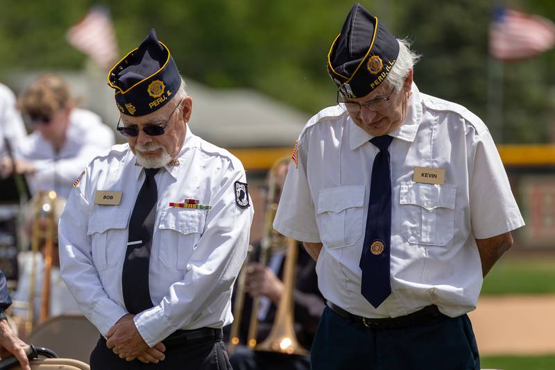 (left to right) Bob and Kevin of the Peru Honor Guard bow heads during prayer on Monday, May 26, 2025 at Washington Park in Peru.