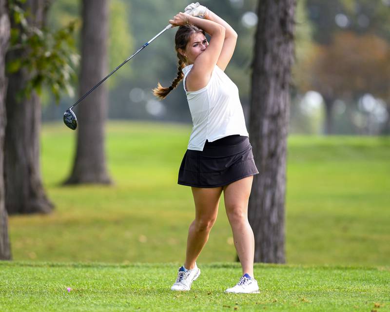 Peyton Theisen of Geneva watches as tees off during the DuKane conference meet on Tuesday Sept. 23, 2025, held at Phillips golf course in Aurora.