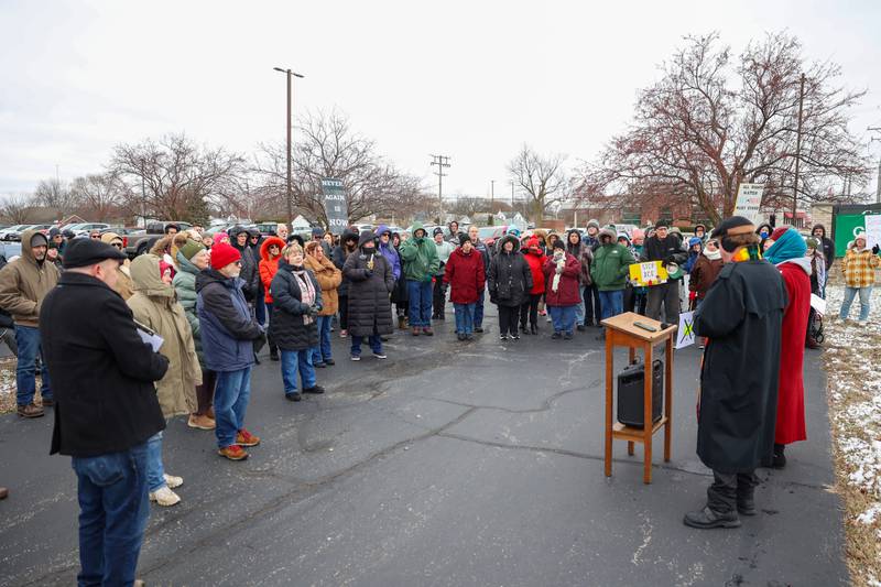 Pastors Robert Bushey and Lana Robyne, at right, lead a crowd of about 100 in a song during an ICE Out for Good protest and vigil at The Grow Center in Bourbonnais on Sunday, Jan. 11, 2026. The event was planned in the wake of the shooting death of Renee Nicole Good by an ICE agent on Jan. 7 in Minneapolis, Minn.