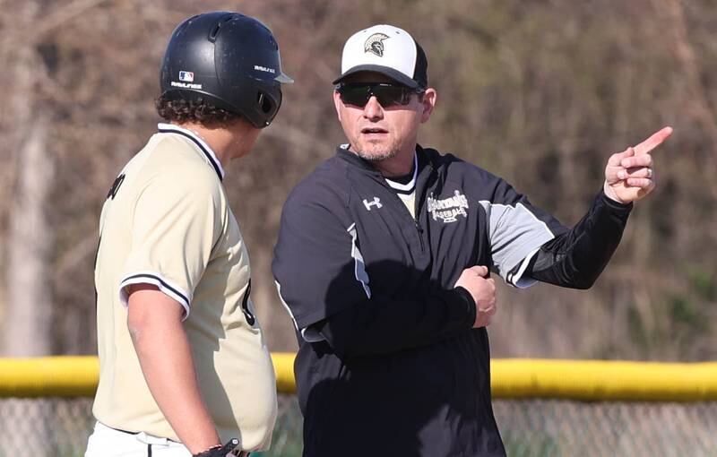 Sycamore's head coach Jason Cavanaugh talks to Matthew Rosado during their game against Kaneland Thursday, May 4, 2023, at Kaneland High School.