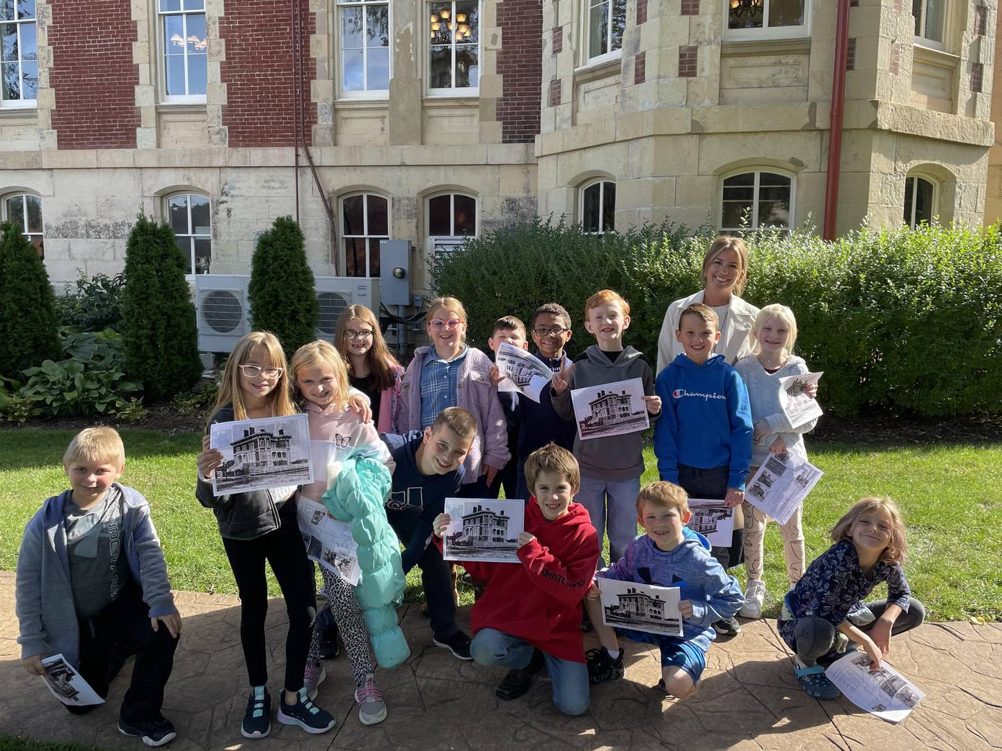 Third graders from Grand Ridge Grade School and their teacher Kara Ericzon pose outside of the Reddick Mansion in Ottawa.