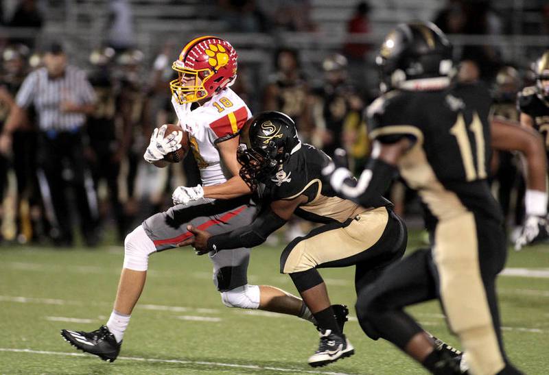 Batavia's Colin Cheaney (left) tries to shake a Streamwood tackler Sept. 9 during a road game. The Bulldogs' homecoming is Sept.16, their first home game of the season and the first game on their new field.