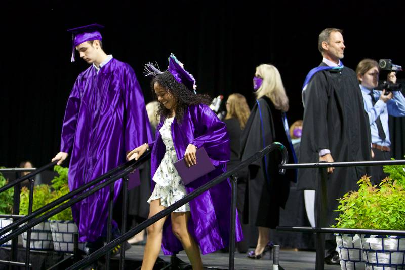Students leave the stage with their diplomas at the Hampshire High School graduation ceremony on May 21, 2022, at the NOW Arena in Hoffman Estates.