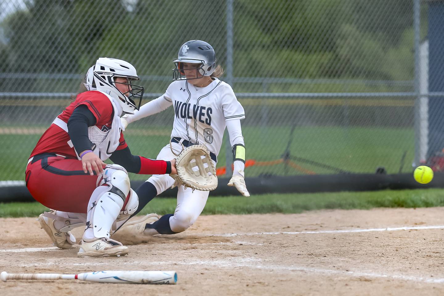 Oswego East's Ronnie Craft (6) slides in to score the winning run during softball game between Yorkville at Oswego East. April 17th, 2024.