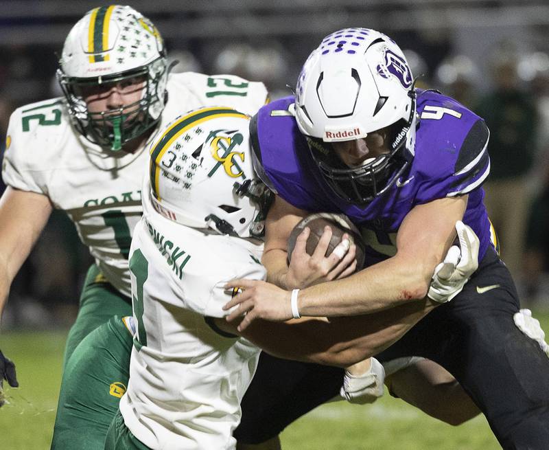Dixon’s Landon Knigge fights for yards against Coal City’s Brody Widlowski Friday, Nov. 7, 2025.