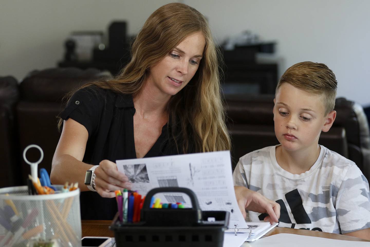 Jessica Clements helps her son Myles, 10, during a homeschooling session with learning materials from The Good and The Beautiful at home on Tuesday, Aug. 17, 2021 in McHenry.  This is the family's first time trying home schooling.  Myles is in 5th grade, Gavin is in 2nd, and Dayne, 4, is in preschool.