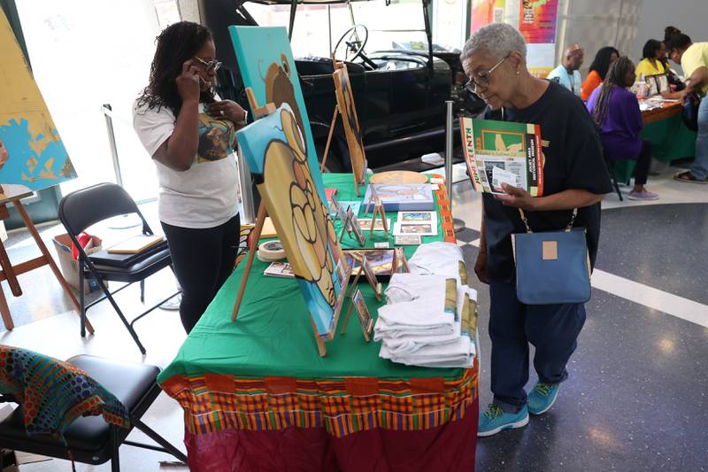 Delphine Johnson, right, of Joliet browses one of the black-owned business tables at the Juneteenth event hosted by the Joliet Area Historical Museum on Monday, June 19, 2023 in Joliet.