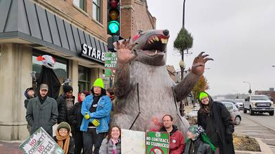 Starbucks’ baristas strike, picket Geneva location with giant rat