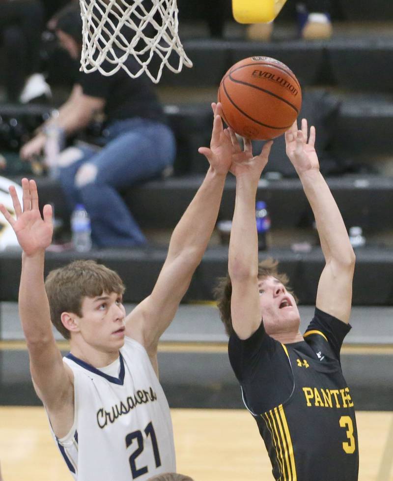 Putnam County's Bryce Smith eyes the hoop as Marquette's Charlie Mullen defends during the Tri-County Conference Tournament on Tuesday, Jan. 23, 2024 at Putnam County High School.