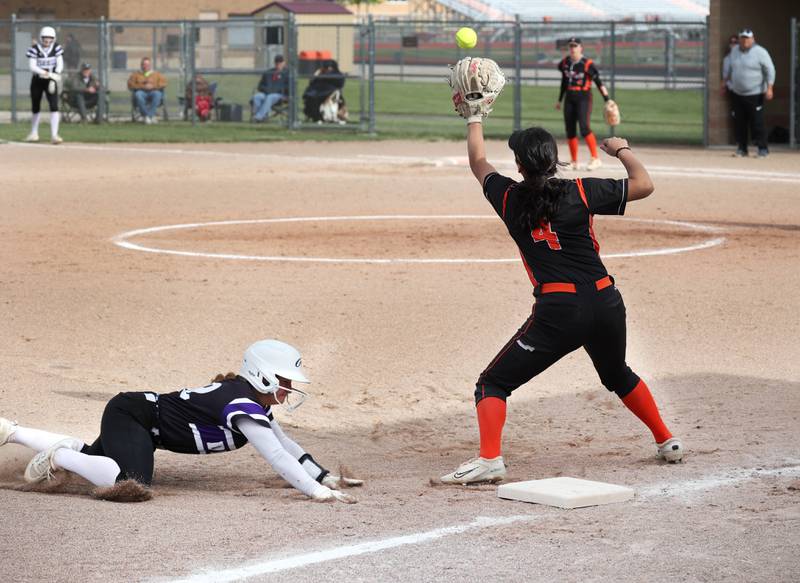 Dixon’s Breanna Tegeler slides in safely to third as DeKalb's Isabel Aranda takes the throw Thursday, May 22, 2025, during their game at DeKalb High School.