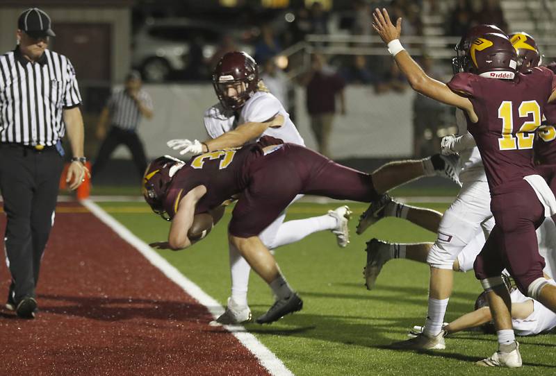 Richmond-Burton’s Steven Siegel scores a touchdown as Marengo’s Owen Frederick tries to tackle him during a Kishwaukee River Conference football game Friday, Sept. 9, 2022, between Richmond-Burton and Marengo at Richmond-Burton Community High School.