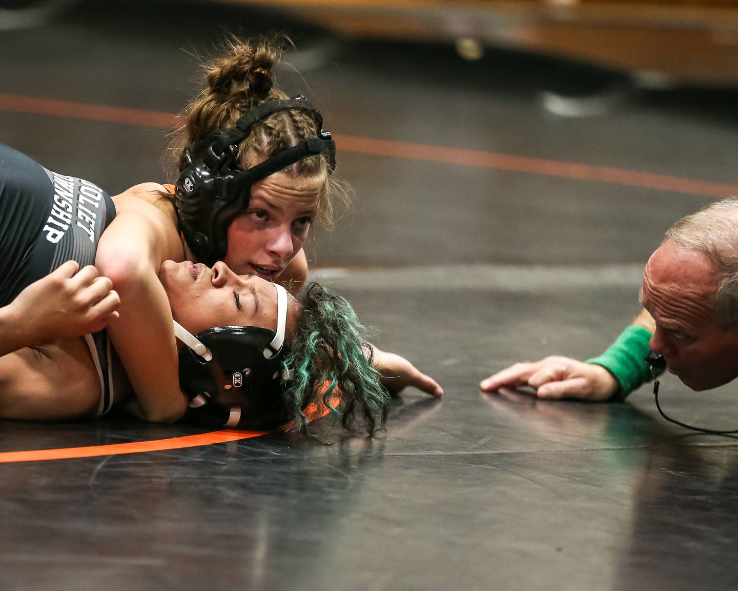 Minooka's Eva Beck looks for the pin on Joliet's Janelle Maldanado during their 135 class match during the Joliet Township at Minooka Girls Wrestling tournament.  Dec. 13, 2023.