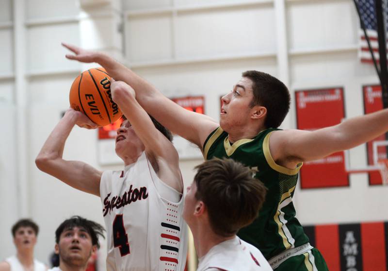 Forreston's Brady Gill (4) draws contact from Peru St. Bede's Haden Huenenburg (5) on Wednesday, Feb. 26, 2025 at the 1A Amboy Regional.