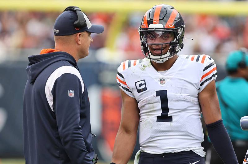 Chicago Bears offensive coordinator Luke Getsy talks to Justin Fields during their game against the Houston Texans Sunday, Sept. 25, 2022, at Soldier Field in Chicago.