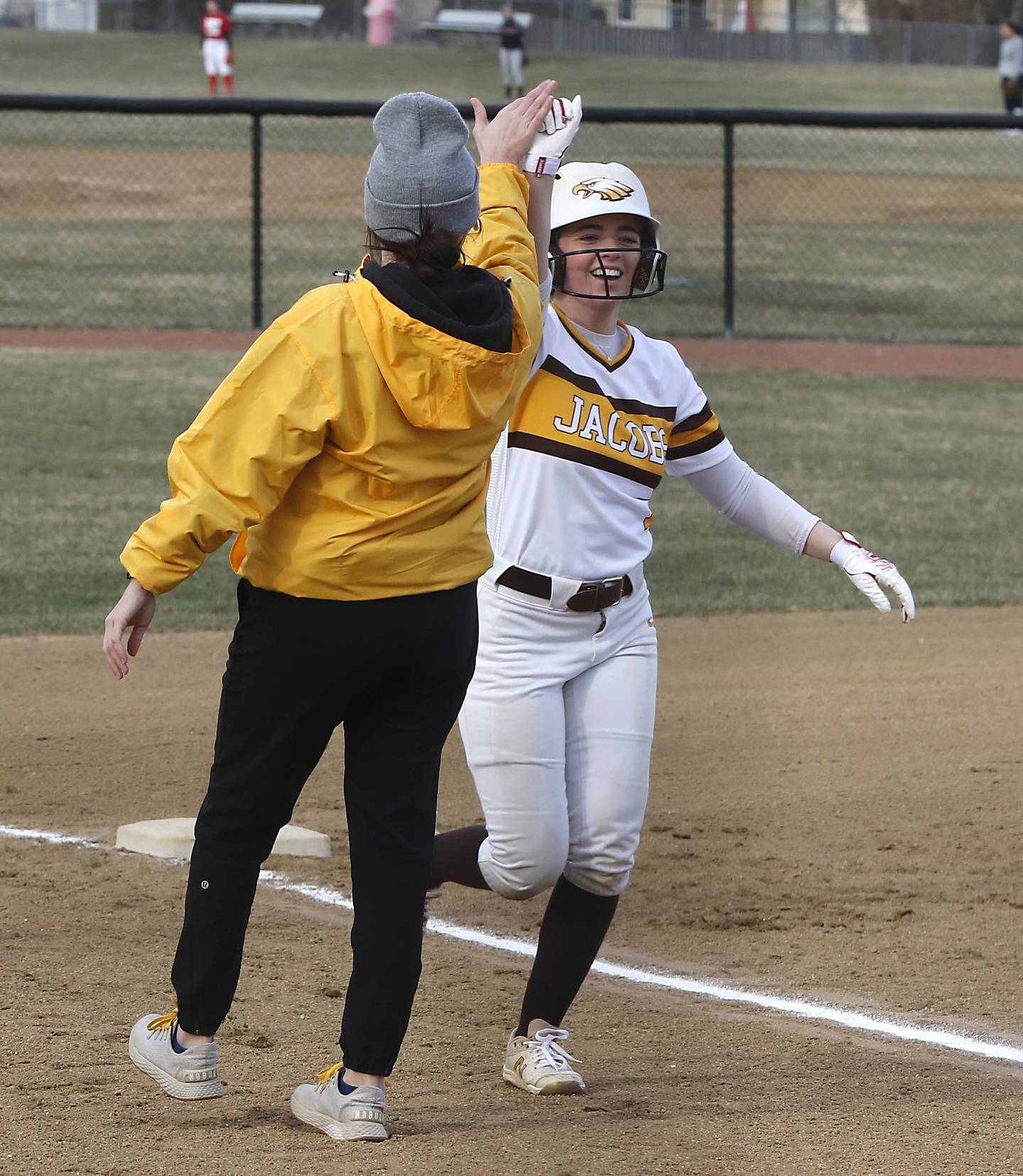 Jacobs’ Taylor Stennett “high fives” her coach Jessica Turner after Stennett hit a homer during a non-conference softball game against Palatine Monday, March 20, 2023, at Palatine High School.