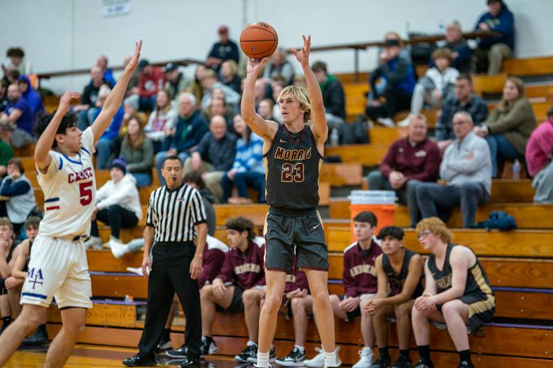 Morris’ Jonah Williams (33) shoots a three-pointer against Marmion's Jacob Piceno (5) during the 59th Annual Plano Christmas Classic basketball tournament at Plano High School on Tuesday, Dec 27, 2022.