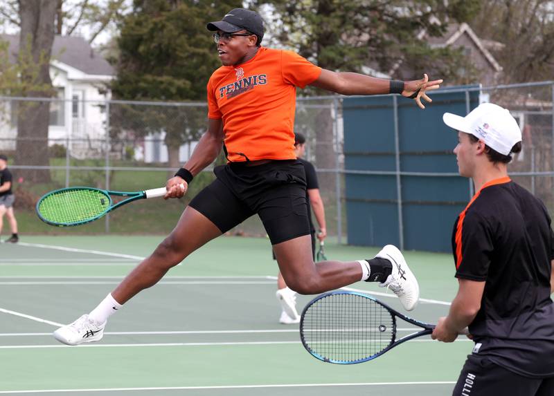 DeKalb number one doubles player Matthew Williams jumps to hit a shot Thursday, April 24, 2025, during their match at Sycamore High School.