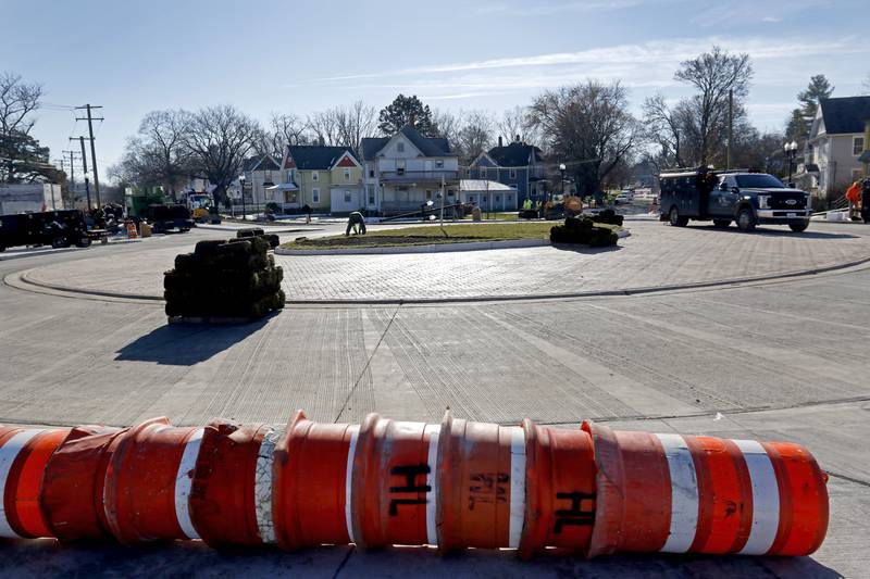 Workers put the finishing touches on the Woodstock roundabout at intersection of Lake Avenue and South and Madison streets on Tuesday Nov. 22, 2022. Construction on the roundabout near Woodstock's downtown is expected to wrap up this week, opening traffic and marking the end of several months of construction. The roundabout has been in the works for several years and was built out this year.