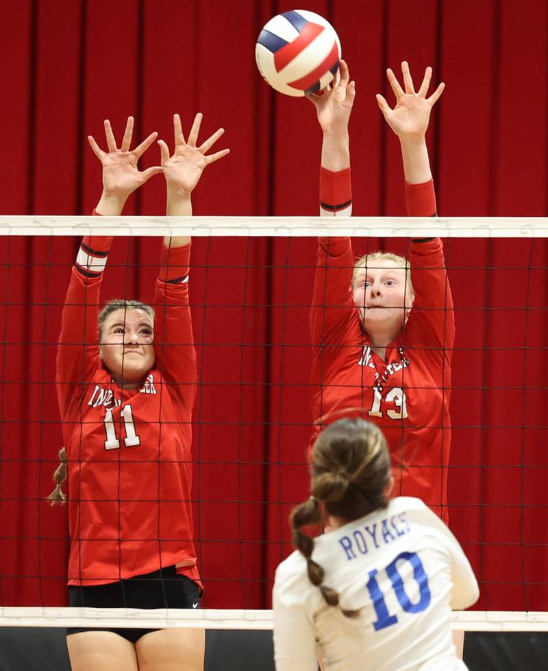 Indian Creek's Ellie Bend (left) and Indian Creek's Allie Peterson try to block the hit by Hinckley-Big Rock's Madaline Hogan during their match Tuesday, Sept. 19, 2023, at Indian Creek High School in Shabbona.
