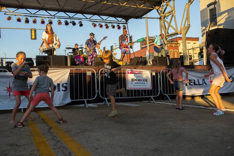 Kids dance to the band “Invisible Cartoons” Sunday, July 3, 2022 at Dixon’s Petunia Fest.