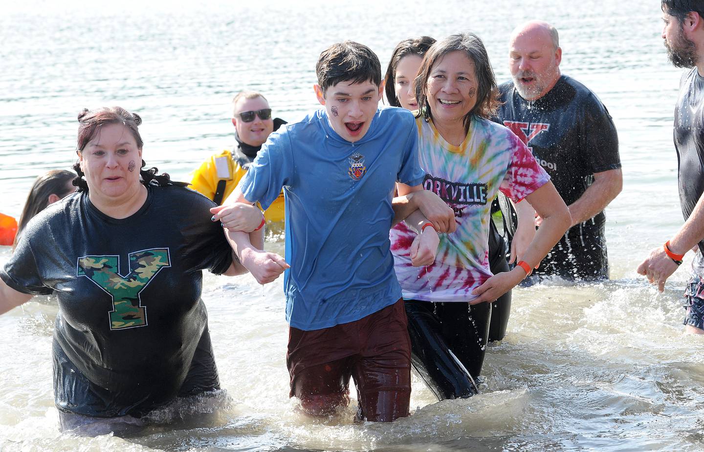 Riley Rutler (left), Sean Nole and Sopheap Mitchell of the Frozen Foxes of Yorkville Middle School walk out of the water during the annual Polar Plunge to support Special Olympics Illinois at Siver Springs State Park's Loon Lake on Sunday, Mar. 5, 2023.