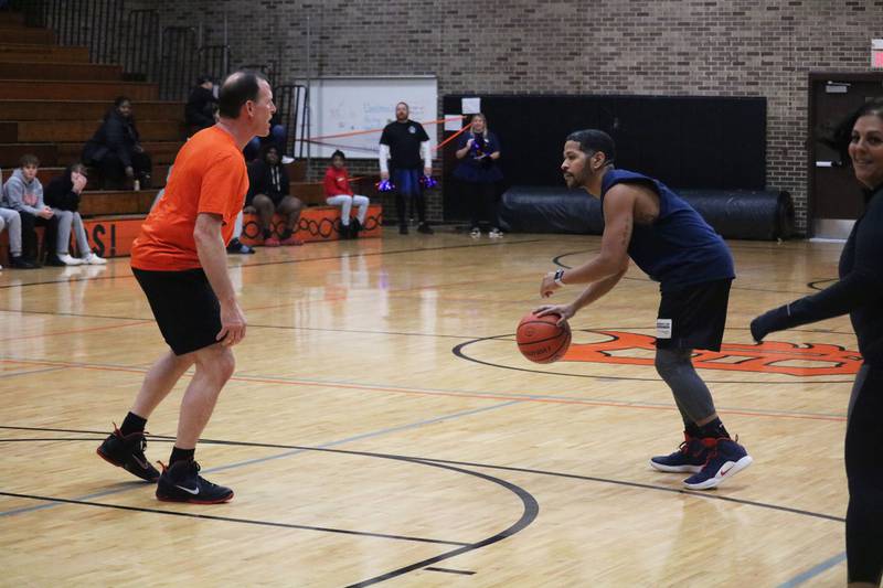 Ray Hernandez (right) takes to the hardwood dribbling Monday, Dec. 5, 2022 in the Toys for Tots community basketball game.
