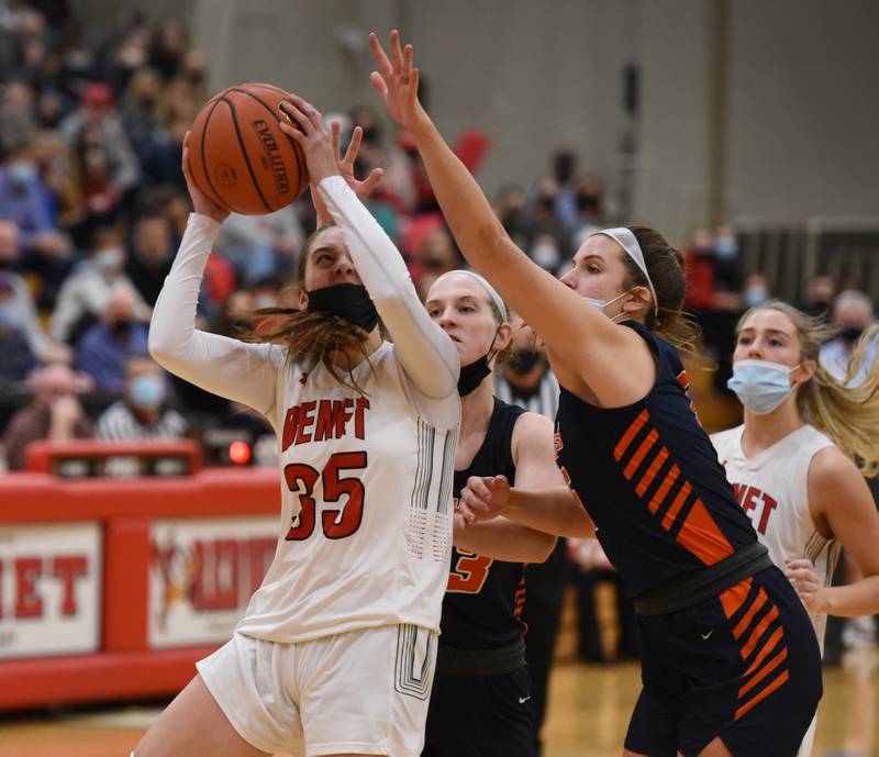 Benet's Emilia Sularski (35) fights through the Naperville North defense to take a shot during MondayÕs girls basketball game in Lisle.