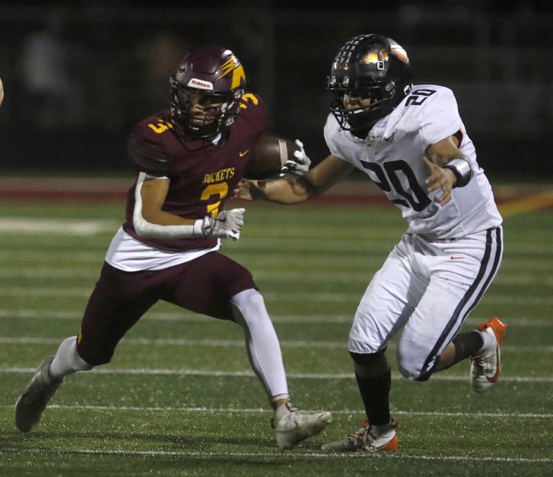 Richmond-Burton's Oscar Bonilla runs with the ball as Sandwich's Diego Gomez closes in during a Kishwaukee River Conference football game on Friday, Oct. 4, 2024, at Richmond-Burton High School.