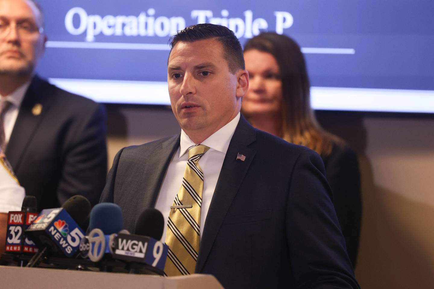 Joliet Detective James Kilgore speaks at a press conference regarding a joint operation that resulted in arrest and indictment of 25 defendants in a Paycheck Protection Program loan fraud. Wednesday, Sept. 21, 2022, in Joliet.