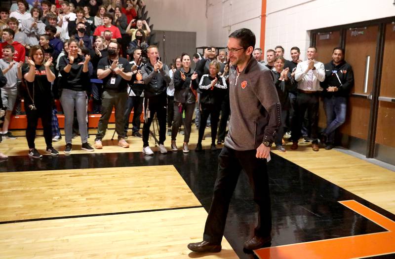 Wheaton Warrenville South teacher Philip Culcasi walks into the school’s gymnasium during an assembly to announce his Golden Apple Award for Excellence in Teaching on Friday, May 6, 2022.