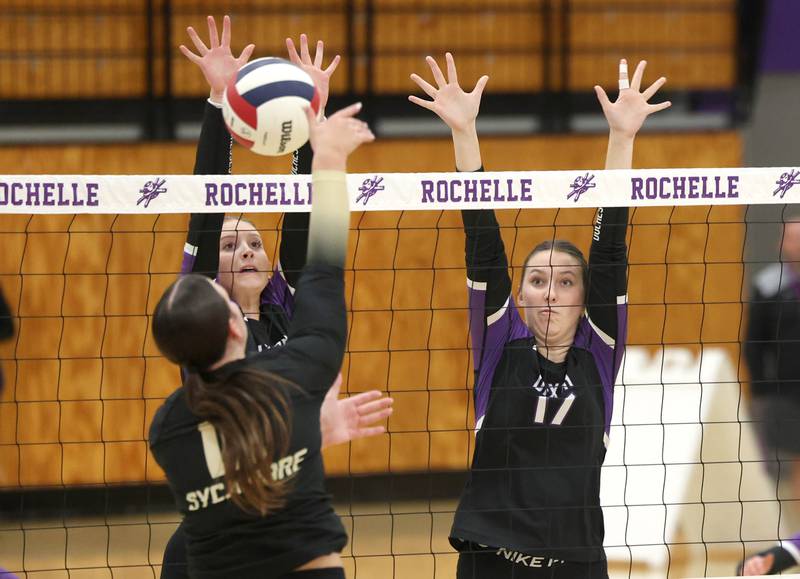 Dixon’s Izzy Queckboerner (left) and Lucy Feick try to block the spike of Sycamore's Sophia Lichthardt Thursday, Oct. 30, 2025, during their Class 3A regional championship match in Rochelle