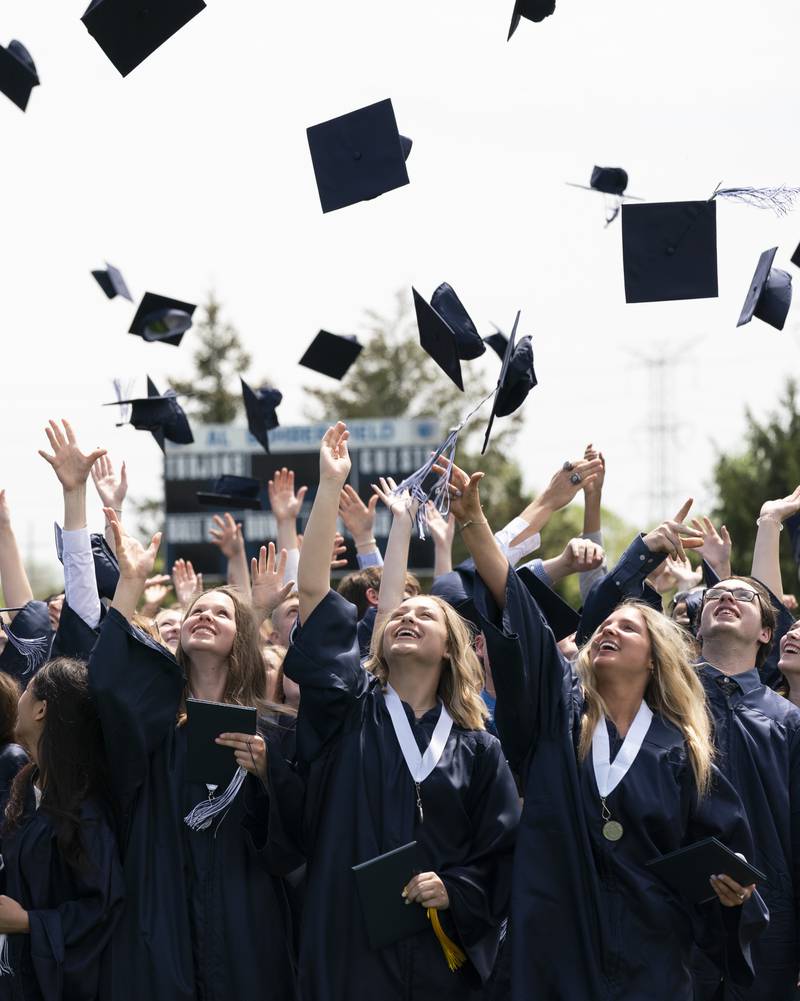 Graduates celebrate after receiving their diplomas during a graduation ceremony for the class of 2022 on Saturday, May 14, 2022, at Cary-Grove High School in Cary.
