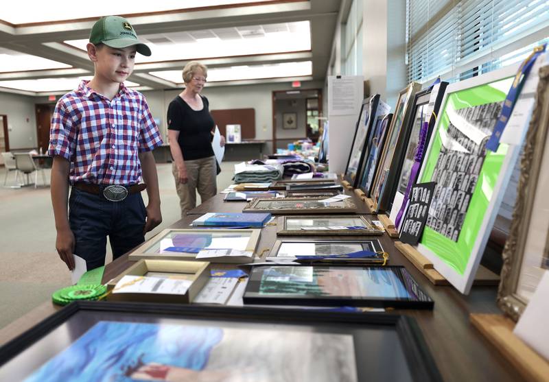 Harlan Marshall, 9, from DeKalb, and his grandma Sharon Marshall, also from DeKalb, check out some of the exhibits Thursday, July 14, 2022, at the 4-H General Project Show at the DeKalb County Farm Bureau in Sycamore.