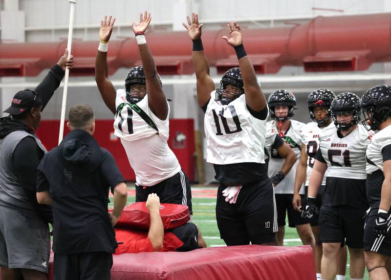 Northern Illinois University defensive tackles Skyler Gill-Howard (left) and Demond Taylor Jr. go through a drill Wednesday, July 31, 2024, at practice in the Chessick Practice Center at NIU.