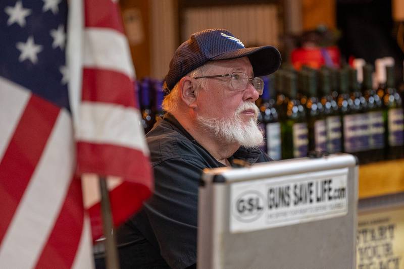 Glenn Pratt watches on as John Bosch speaks at the 'Guns Save Life' event on Thursday, Aug 21, 2025 at Jamie's Outpost in Utica.