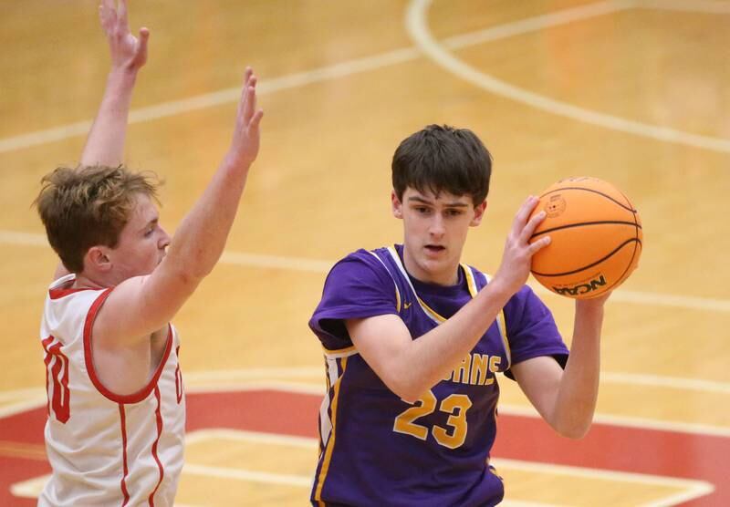 Mendota's Dane Doyle looks to pass around Ottawa's Evan Snook on Tuesday, Jan. 7, 2025 in Kingman Gym at Ottawa High School.