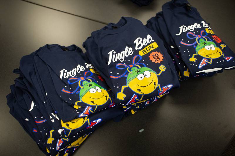 Shirts sit on a table for the 35th annual Jingle Bell Run river at Kankakee Community College on Sunday, December 7, 2025.
